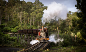 A shaft of sunlight breaks through the storm clouds over the Monbulk Creek trestle bridge, as 7A stomps off towards Nobelius Siding.