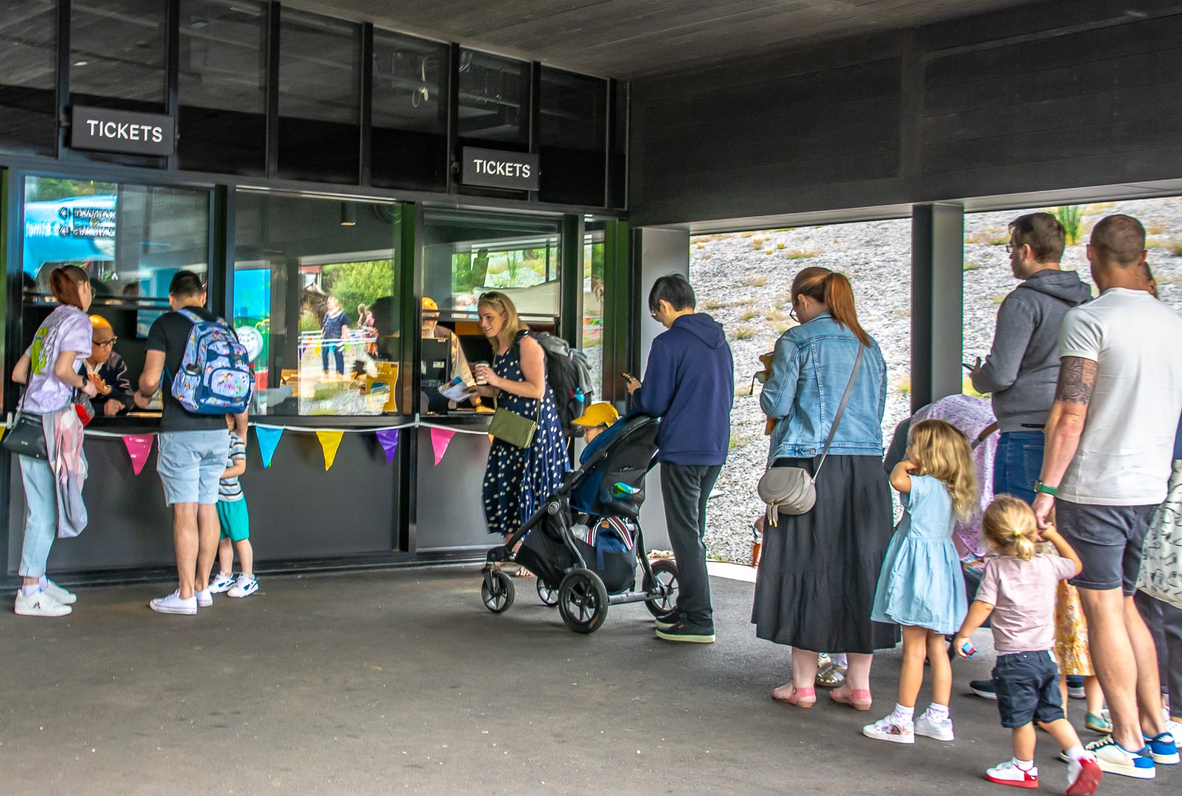 Passengers Lining Up At The Lakeside Station Ticket Window