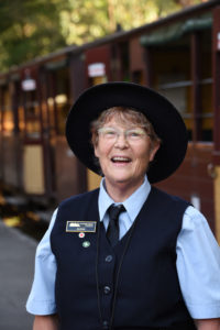 Volunteer Conductor At Belgrave Station Helping Passengers Disembark