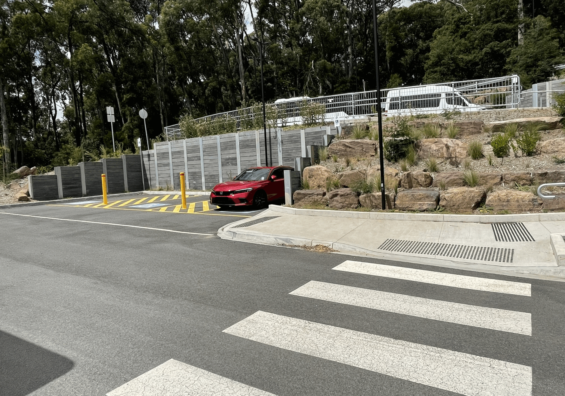 Three accessible car parking spots, with a zebra crossing opposite.