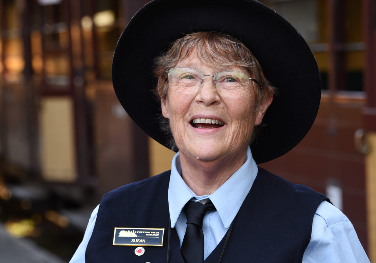 Volunteer Conductor At Belgrave Station Helping Passengers Disembark